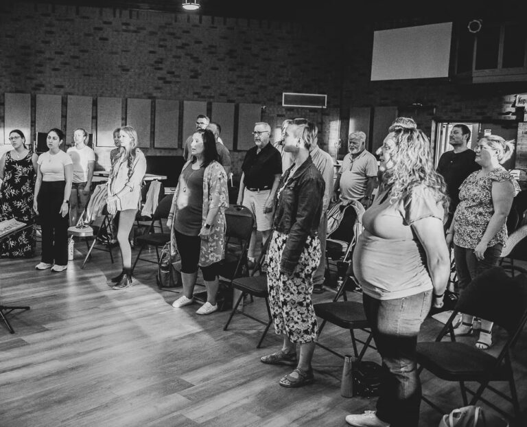 The Harlequin Singers in rehearsal led by director Michael Pin
