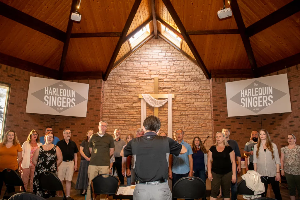 The Harlequin Singers in rehearsal led by Music director Michael Pin